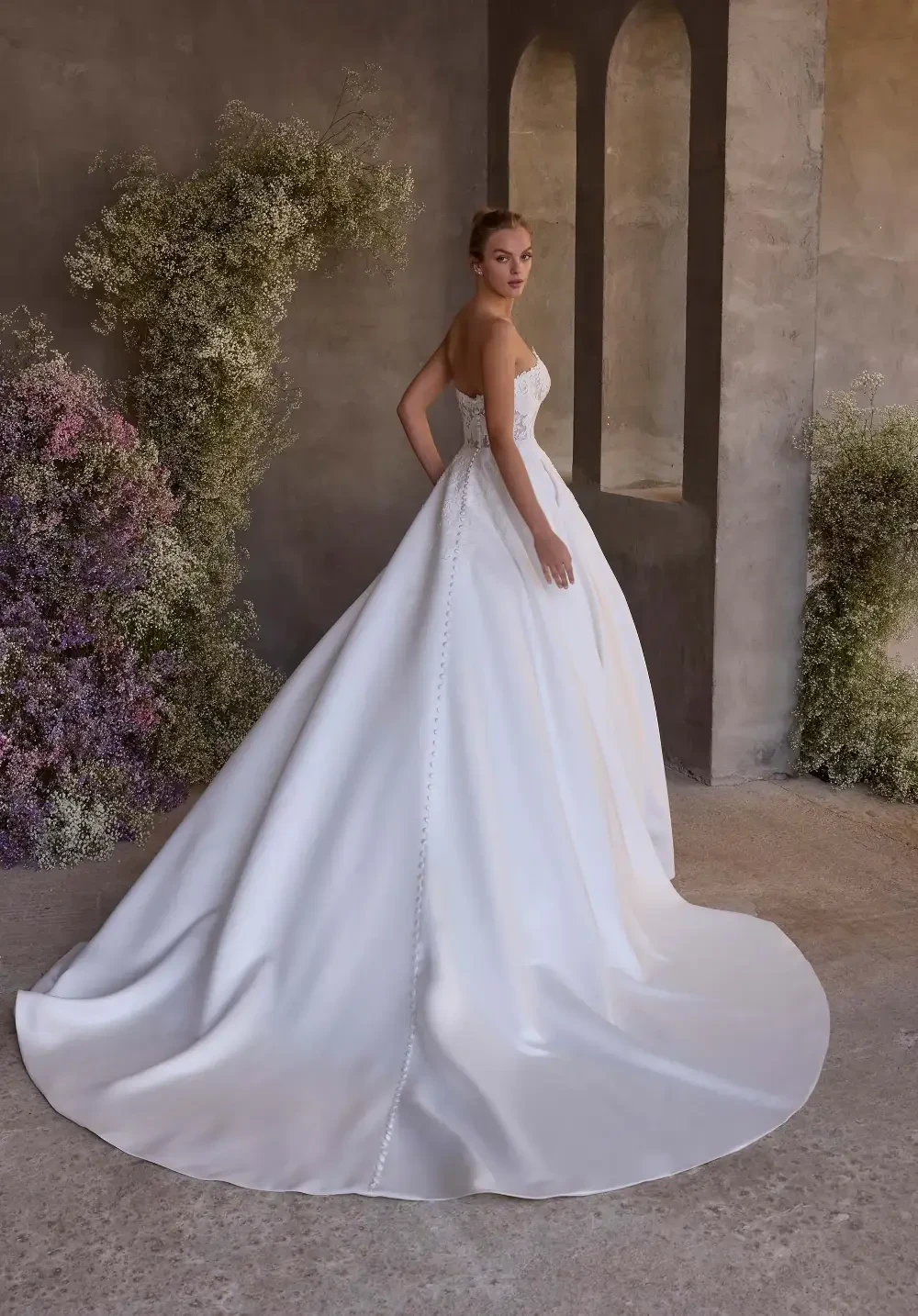model is wearing a sleeveless ball gown