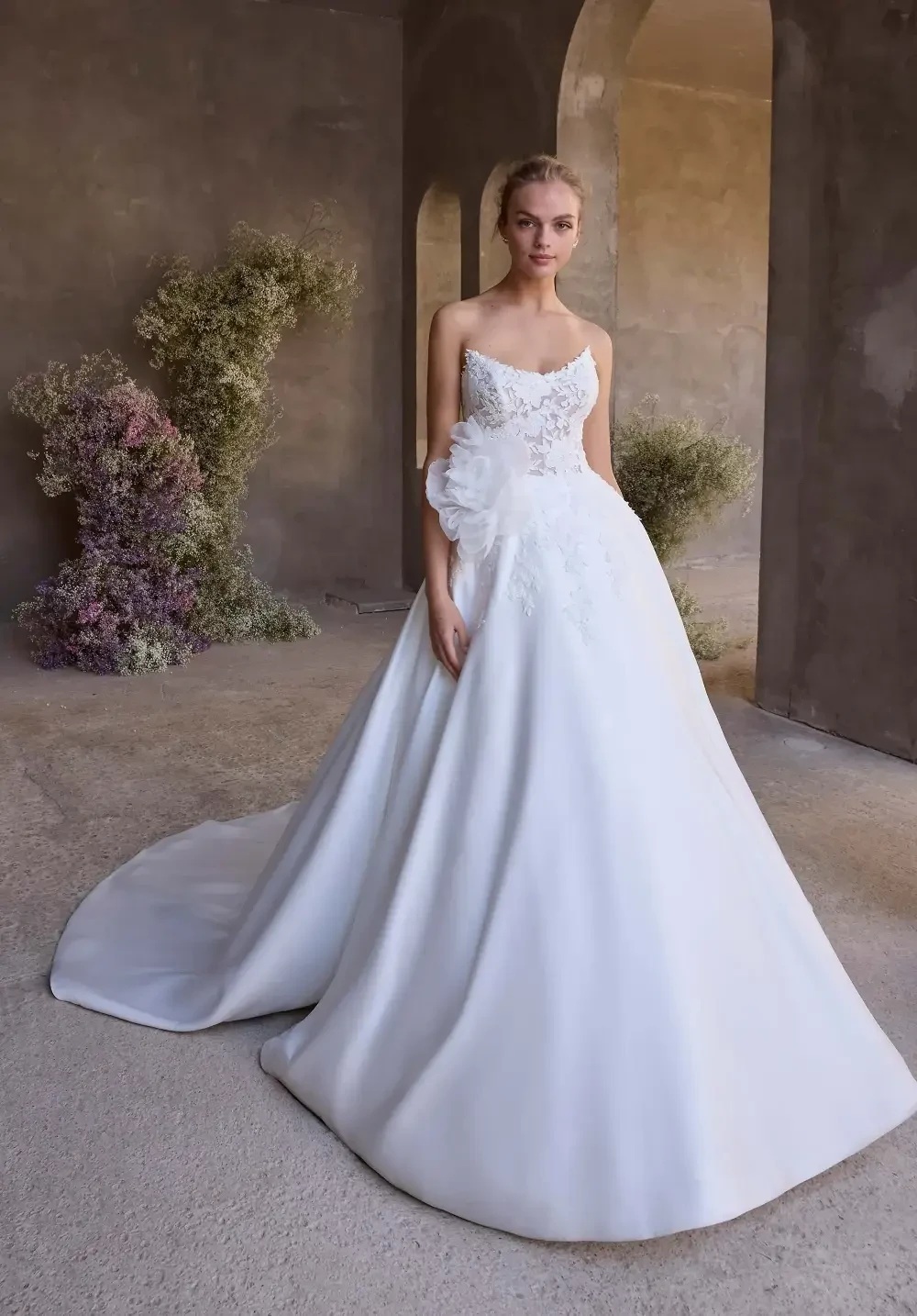 model is wearing a sleeveless ball gown