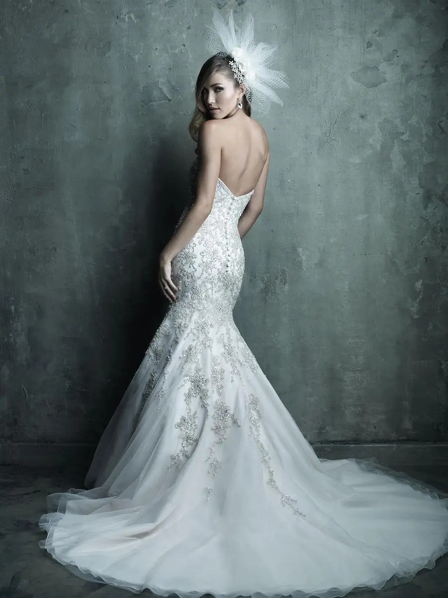 Model is wearing a strapless mermaid wedding dress with swarovski crystal embroidery