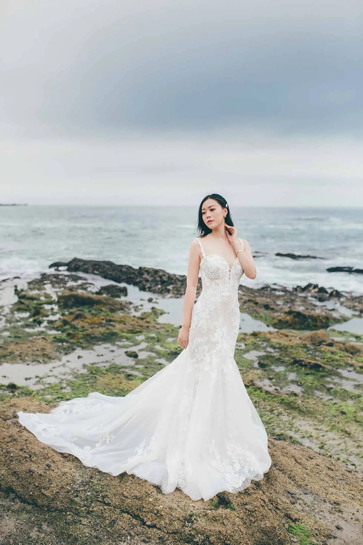 Model is wearing a sweetheart neckline wedding dress with wide straps by essense of australia