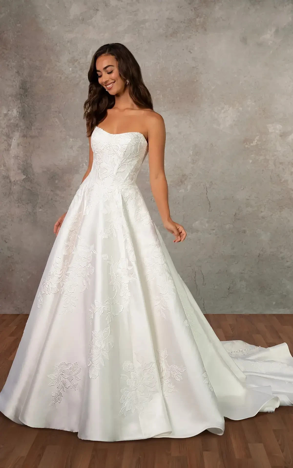 model is wearing a strapless a-line bridal gown