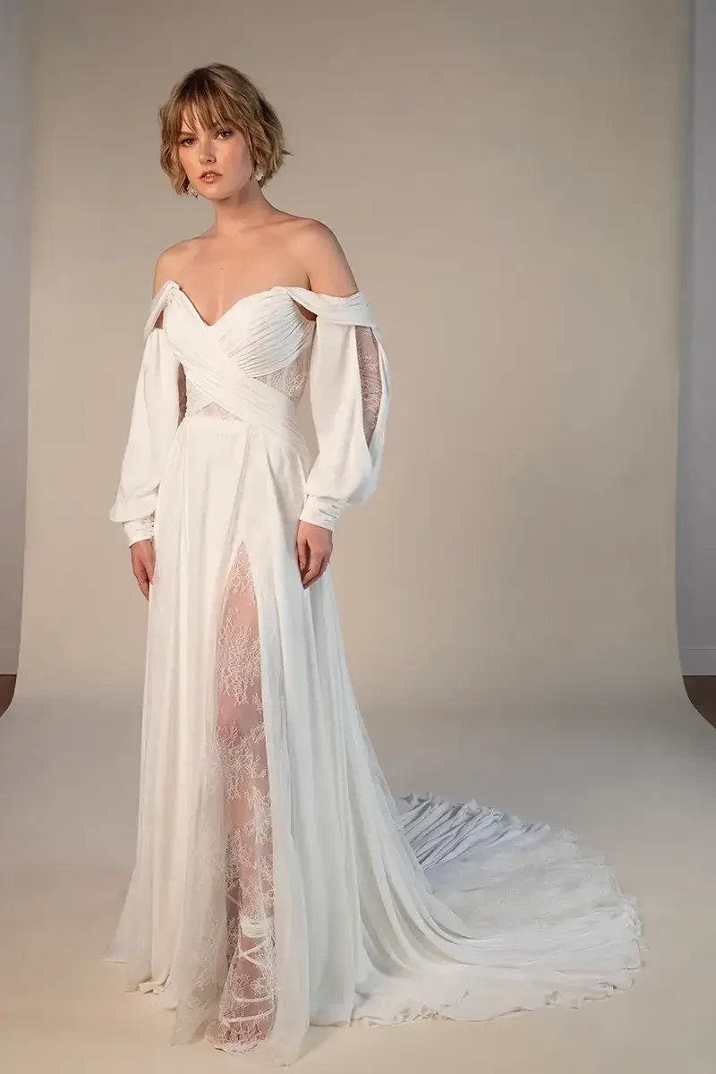 model is wearing an off the shoulder chiffon long sleeve wedding dress