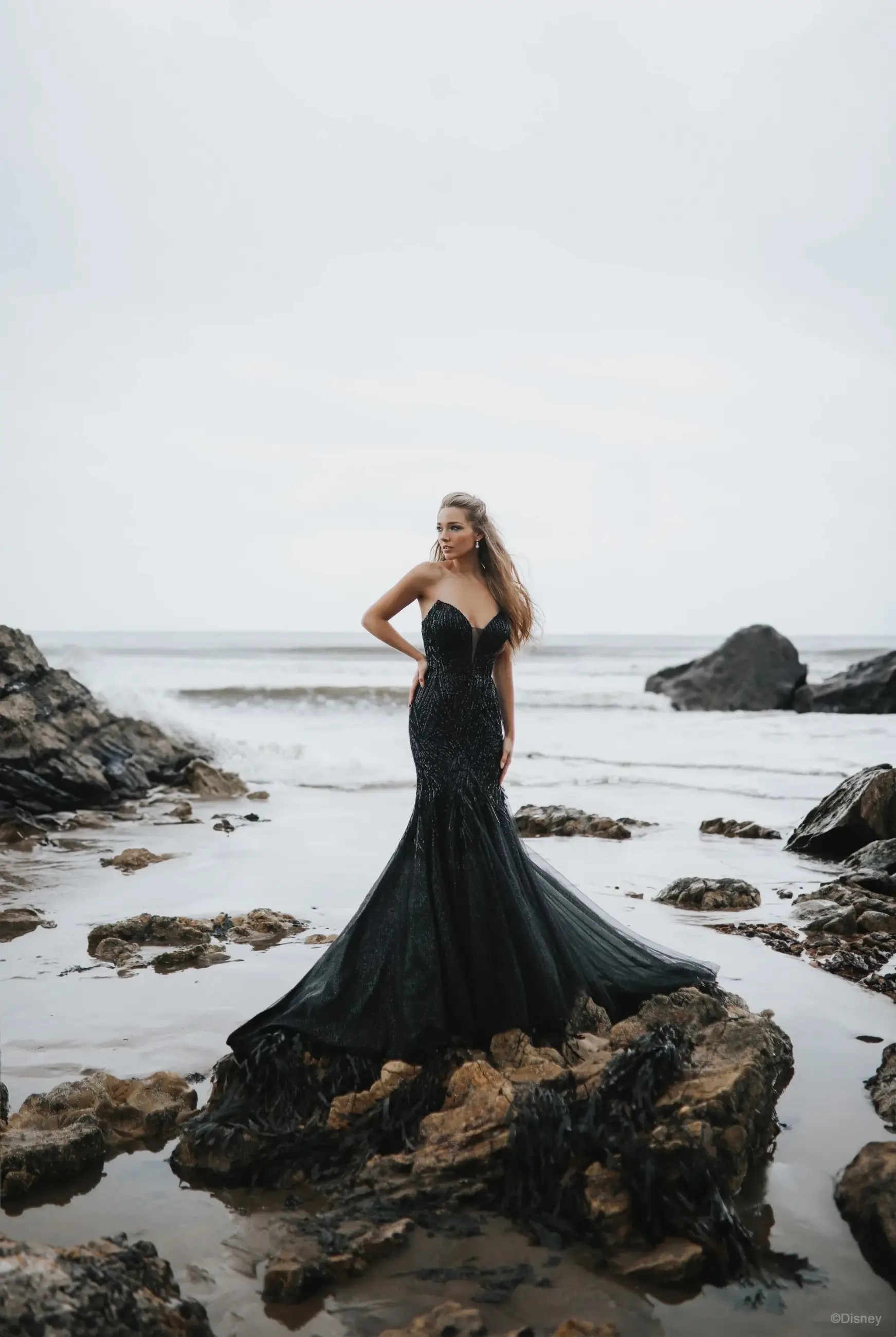 Model is wearing a black tulle bridal gown mermaid dress by disney villains allure