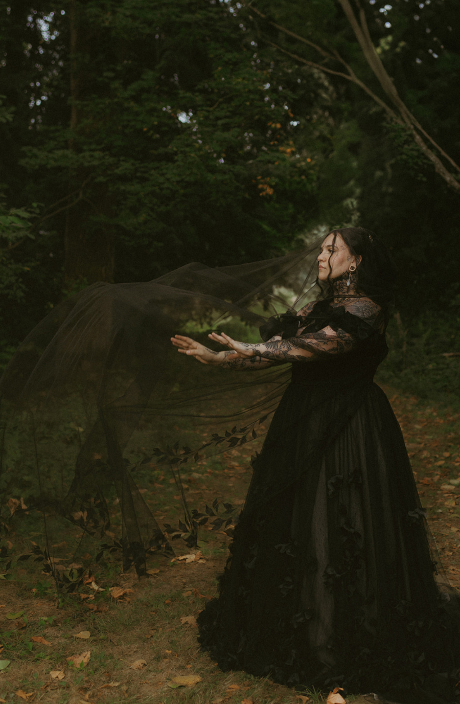 model is wearing a black lace a-line bridal gown