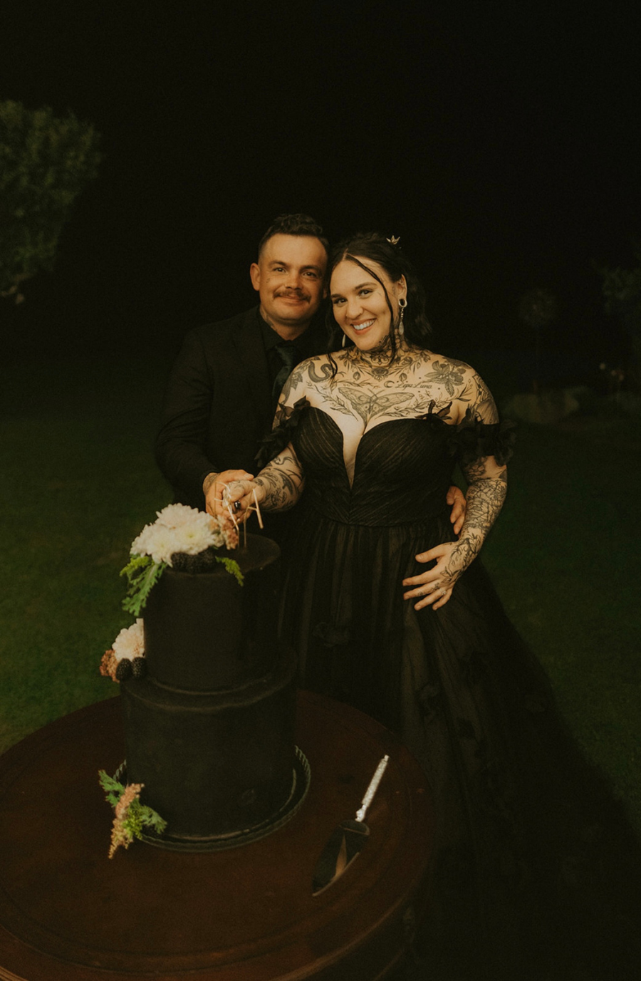 model is wearing a black lace a-line bridal gown