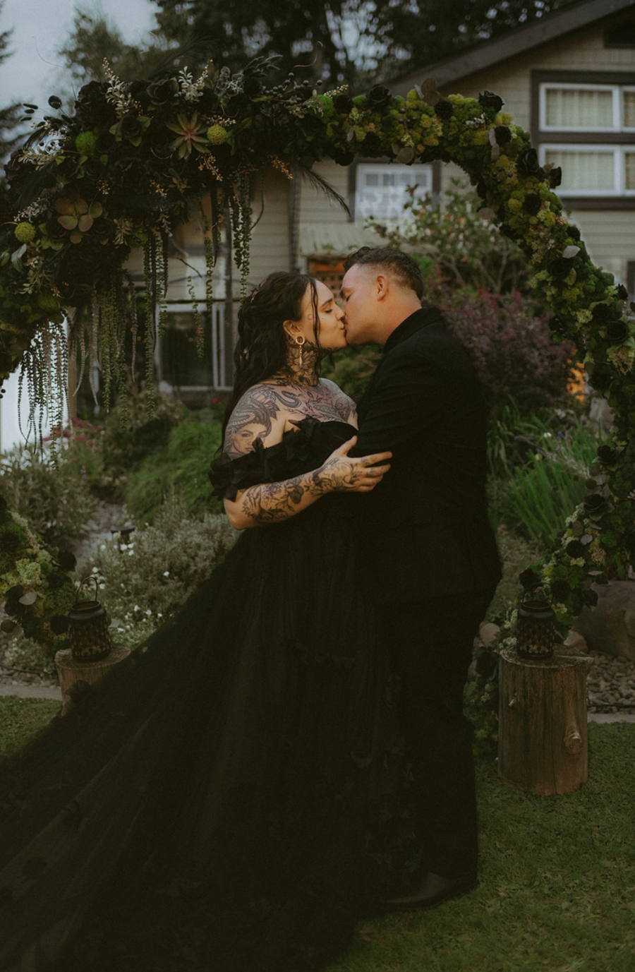 model is wearing a black lace a-line bridal gown