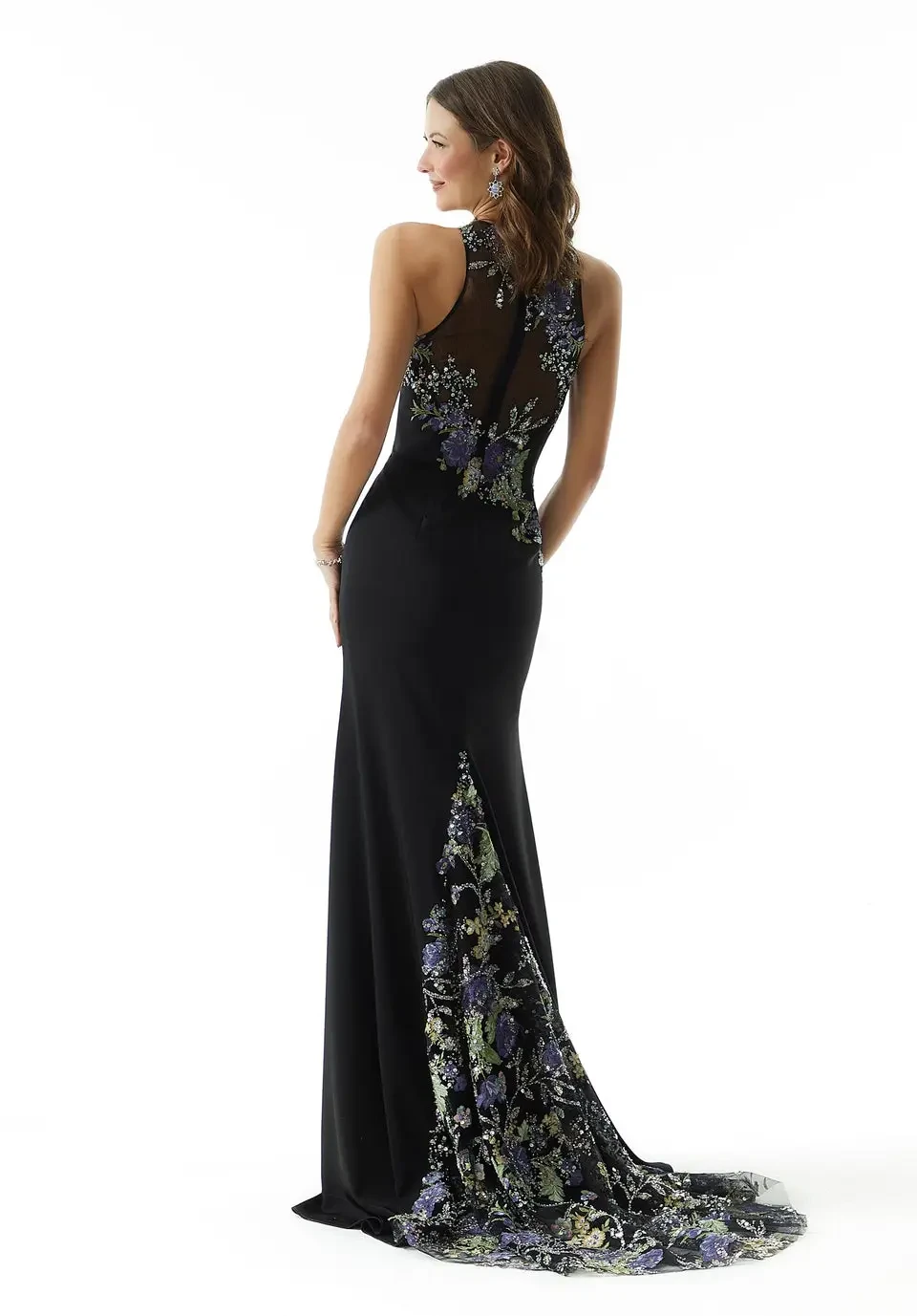 A model wearing a black dress with floral embroidery on one side, posing against a white background.